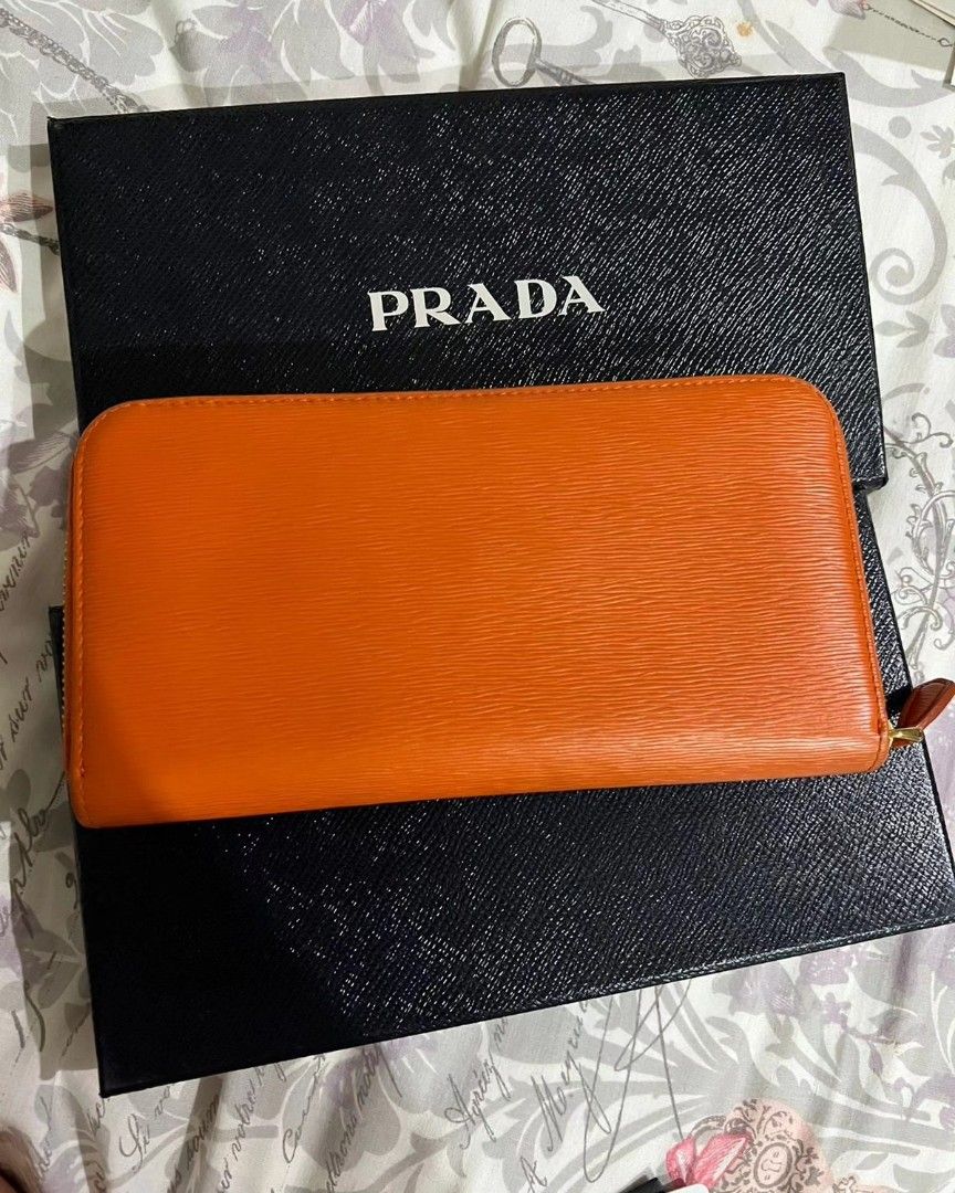 PRADA zip wallet (Category: Luxury Bags & Wallets) located in Quezon City. Submitted by rmseller.2017 (Listing ID 1262100344, Image 2). Description: PRADA zip wallet | vitello move | color: papaya | with box and authenticity card | like new | bought in HK for P28K| P12500 only.