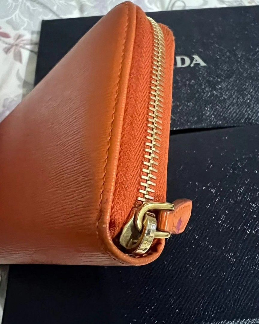 PRADA zip wallet (Category: Luxury Bags & Wallets) located in Quezon City. Submitted by rmseller.2017 (Listing ID 1262100344, Image 3). Description: PRADA zip wallet | vitello move | color: papaya | with box and authenticity card | like new | bought in HK for P28K| P12500 only.