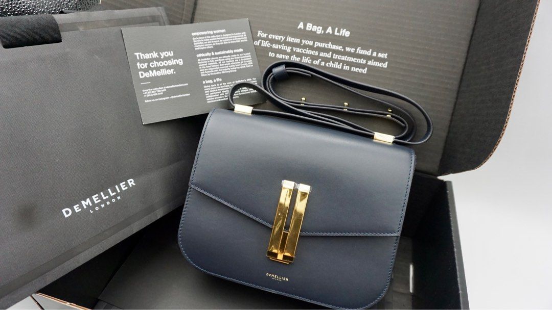 DeMellier Vancouver navy smooth (Category: Luxury Bags & Wallets) located in Manila. Submitted by samwear (Listing ID 1238521289, Image 2). Description: -Slightly used with hardware wrap -Bought personally in UK (I can provide screenshot of receipt) -dust bag, paper bag included -Quiet Luxury 💯 Top Width: 23cm/9” Base Width: 23cm/9” Height: 18cm/7” Depth: 7cm/3” Min. Strap Length: 106cm/42” Max. Strap Length: 116cm/45” Weight: 600g Devices: This
