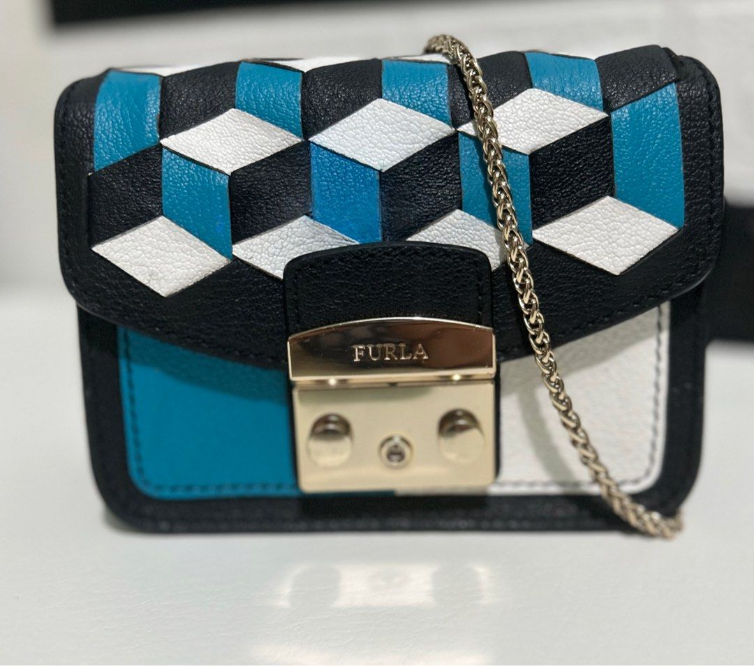 FURLA Metropolis Mini (Category: Luxury Bags & Wallets) located in Dagupan City. Submitted by luckyluxbyemgee (Listing ID 1262635884, Image 1). Description: AUTHENTIC‼️ MONEYBACK IF PROVEN FAKE👍🏻 FURLA Metropolis Mini Woven Leather Crossbody Black/White/Blue With Sign of use and NO Heavy flaws Very minimal stain inside Cute and classy! pwedeng pwede pa pang rampa gold hardware still in good condition 👍🏻 feel free to pm me for other pics..