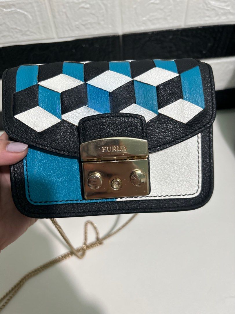 FURLA Metropolis Mini (Category: Luxury Bags & Wallets) located in Dagupan City. Submitted by luckyluxbyemgee (Listing ID 1262635884, Image 2). Description: AUTHENTIC‼️ MONEYBACK IF PROVEN FAKE👍🏻 FURLA Metropolis Mini Woven Leather Crossbody Black/White/Blue With Sign of use and NO Heavy flaws Very minimal stain inside Cute and classy! pwedeng pwede pa pang rampa gold hardware still in good condition 👍🏻 feel free to pm me for other pics..