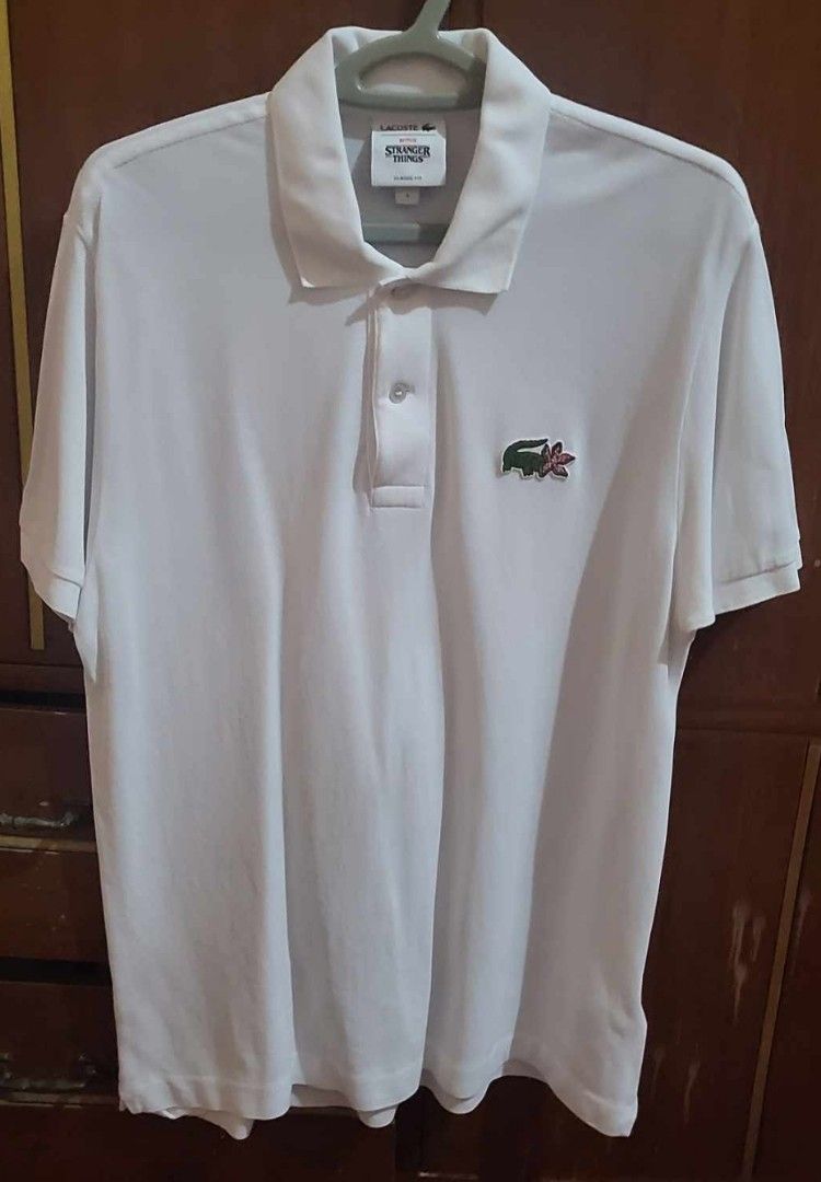 Lacoste x Stranger Things Polo Shirt (Category: Shirts) located in San Pedro. Submitted by marixday (Listing ID 1262496294, Image 1). Description: Original Selling Price: 8K ❤️ Selling for a friend 😊 RFS: Size too big Fits L to XL.