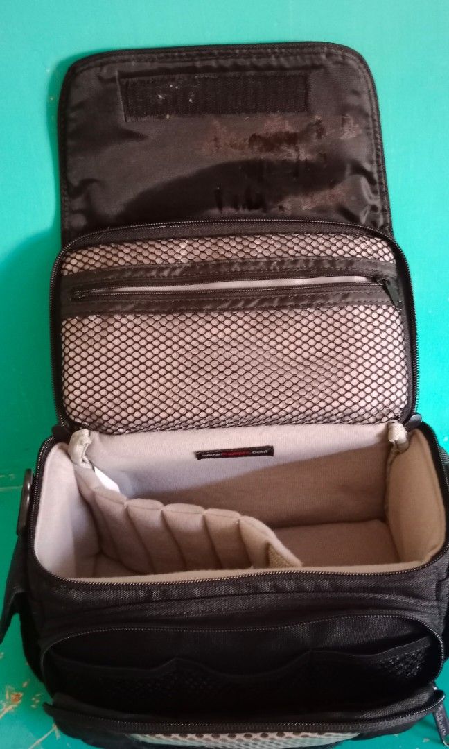 Lowepro camera bag (Category: Camera Bags & Carriers) located in Pasig City. Submitted by bluetolentino (Listing ID 1262861517, Image 3). Description: Lowepro black nylon - no runs, no holes, no rubs can fit 2 gadgets plus accessories with sling strap 9.5 in x 5 in x 4.5 in sign of use: pic #8 - I covered the name of the previous owner using a black permanent marker price negotiable.