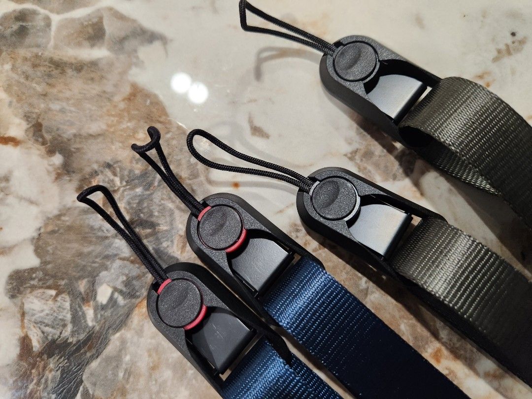 Camera adjustable strap (Category: Cameras) located in Singapore. Submitted by ice_ais (Listing ID 1258977987, Image 2). Description: Adjustable camera strap between 80cm to 120cm. Easy release anchor mechanism. 2 units available army green and deep sea blue..