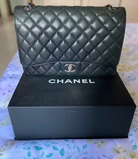 At Auction: A CHANEL BLACK QUILTED CAVIAR LEATHER MAXI CLASSIC