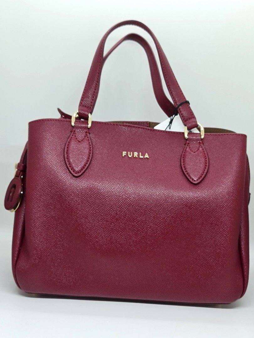 Furla Minerva Tote Bag With Leather Strap (Category: Luxury Bags & Wallets) located in Binan City. Submitted by mommysellsph (Listing ID 1263261074, Image 1). Description: Fresh from UK 100% authentic Has a leather strap to convert it to a crossbody bag.