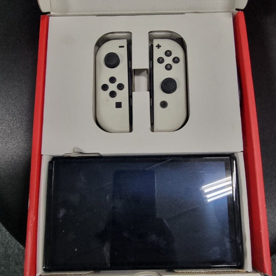 Nintendo Switch OLED (Category: Nintendo) located in Singapore. Submitted by 00htkh (Listing ID 1263247213, Image 1). Description: Nintendo switch OLED with original accessories with some downloaded games and 6 game cartridges. extra controller. self collect at 10 ubi crescent lobby D #07-76A 408564.