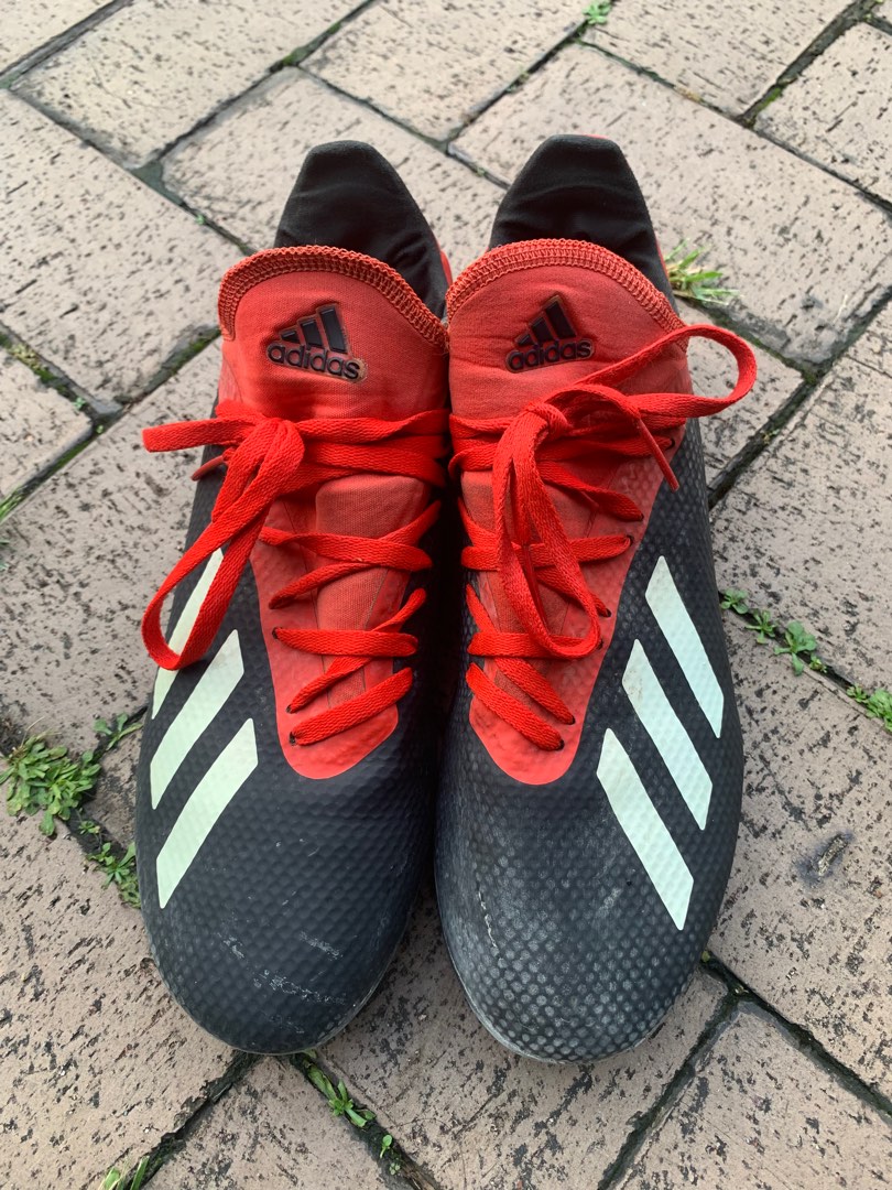 red and black adidas soccer shoes