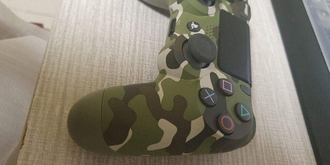 Authentic Green Camo DUALSHOCK4 Wireless Controller (Category: Controllers) located in Quezon City. Submitted by jianmorata89759 (Listing ID 1264920918, Image 3). Description: NEGOTIABLE.Selling my authentic secondhand ps4 controller. Bought last October 2022 due to impulse. Only used once or twice . Works perfectly and has no issues. RFS: Decluttering and need funds. MEET UP ONLY, will not entertain delivery requests..