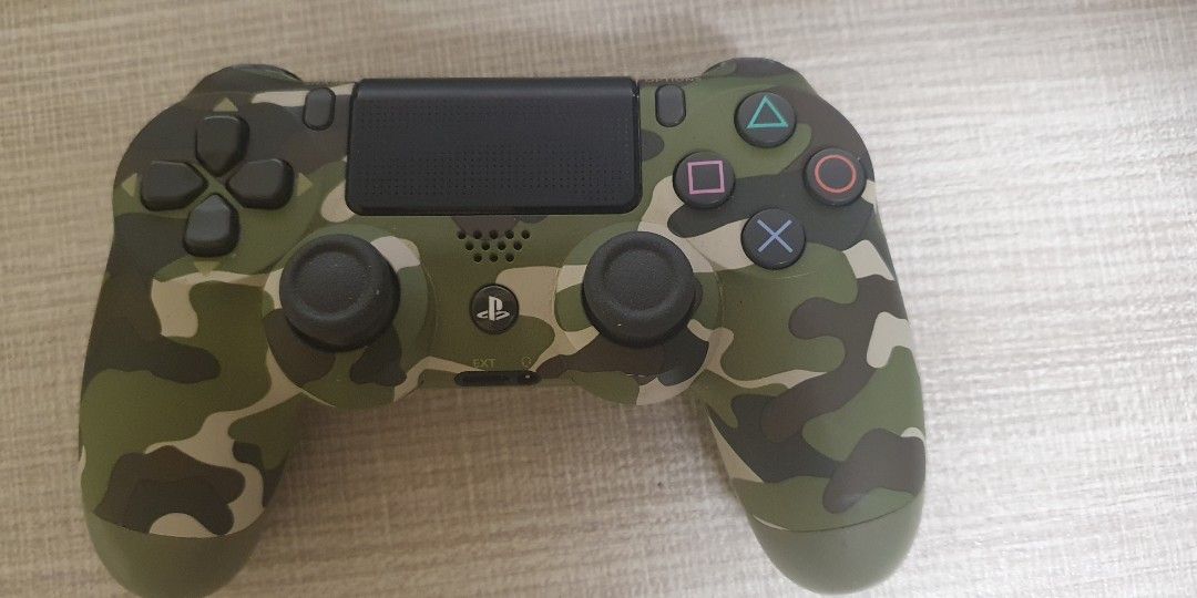 Authentic Green Camo DUALSHOCK4 Wireless Controller (Category: Controllers) located in Quezon City. Submitted by jianmorata89759 (Listing ID 1264920918, Image 1). Description: NEGOTIABLE.Selling my authentic secondhand ps4 controller. Bought last October 2022 due to impulse. Only used once or twice . Works perfectly and has no issues. RFS: Decluttering and need funds. MEET UP ONLY, will not entertain delivery requests..