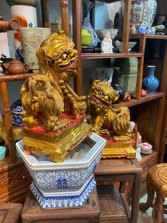 A pair of wooden vintage Peranakan lions