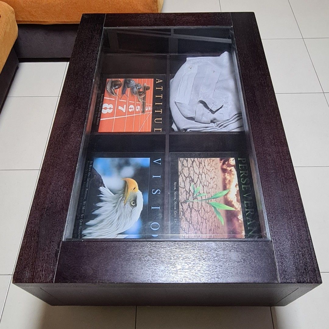 Solid wood coffee table (Category: Tables & Sets) located in Singapore. Submitted by hhquek (Listing ID 1265308243, Image 2). Description: Very sturdy and functional. Dimension: L 110cm x W 72cm x H 39.5cm Has 4 internal compartments so can store many things below or you can display items as a showcase. Each compartment is L 43cm x W 32cm x H 10cm.