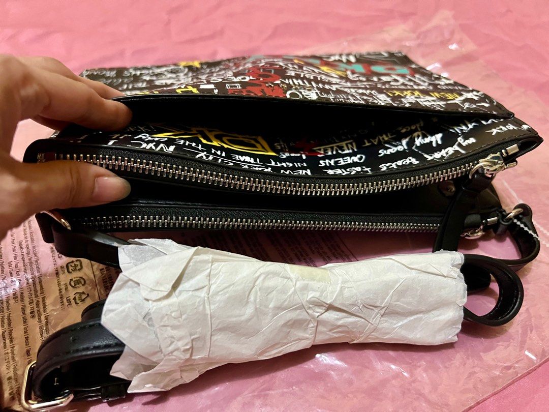 Authentic DKNY Double Zip Cross -body Bag (Category: Luxury Bags & Wallets) located in Las Pinas. Submitted by myluckyeight (Listing ID 1265522972, Image 3). Description: Authentic and brand new with tags Double zip with middle compartment Silver hardware Graffiti design .