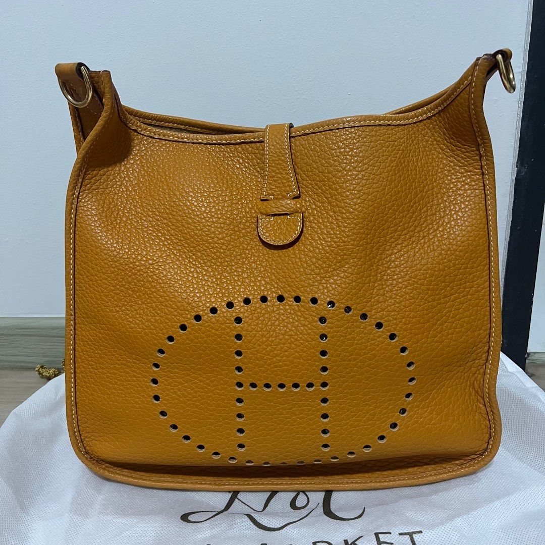 (Fast deal) Hermes Evelyn GM 33 Clemence Leather Mustard Yellow (Category: Bags & Wallets) located in Singapore. Submitted by jang_aixin (Listing ID 1265501680, Image 1). Description: Fast deal $2000. Authentic. Vintage piece, Clemence leather, serial (with date stamp): R Square G Comes with Amazon strap (non adjustable, canvas) and preloved luxury shop in-house dustbag. Have slight storage smell. Feel free to pm if interested. Viewing welcome to
