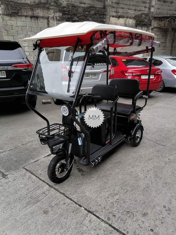 super fashion ebike (Category: Bicycles) located in Manila. Submitted by saguittarian06 (Listing ID 1265998939, Image 3). Description: Super FASHION ebike 3 wheels,2 rows with ROOF! INCLUSIONS: Unit with complete accessories Side mirror with trapal automatic wiper Colors avail Black in Glossy Violet Gray Blue green Specs. With wiper With panel With anti theft alarm 3 seater Front & Back Basket Battery Lead Acid 48v 20AH 650Watts 40-50Km Range 40-