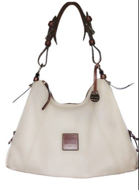 Douney & Bourke bag and wallet (Category: Luxury Bags & Wallets) located in Cavite. Submitted by elmzcloset (Listing ID 1266232438, Image 1). Description: selling set for 3k if sold separately bag is 2500 and wallet is 1500 original item pre-loves with signs of usage. still very presentable in actual. Cream pebbled leather w/ brown leather trim Too zip closure Slightly adjustable strap 10" drop Interior zip pocket and small open pocket key clip G