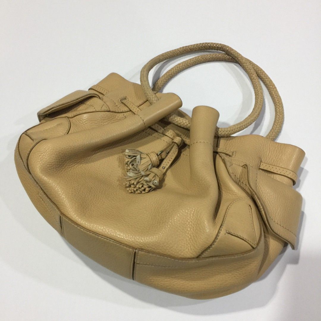 COLE HAAN Leather Braid Handle Bag (Category: Luxury Bags & Wallets) located in Quezon City. Submitted by pleasehelpmedeclutter (Listing ID 1263524043, Image 1). Description: • authentic • no inclusion • preloved (please manage your expectations) • open for meetup (faster and safer transaction).