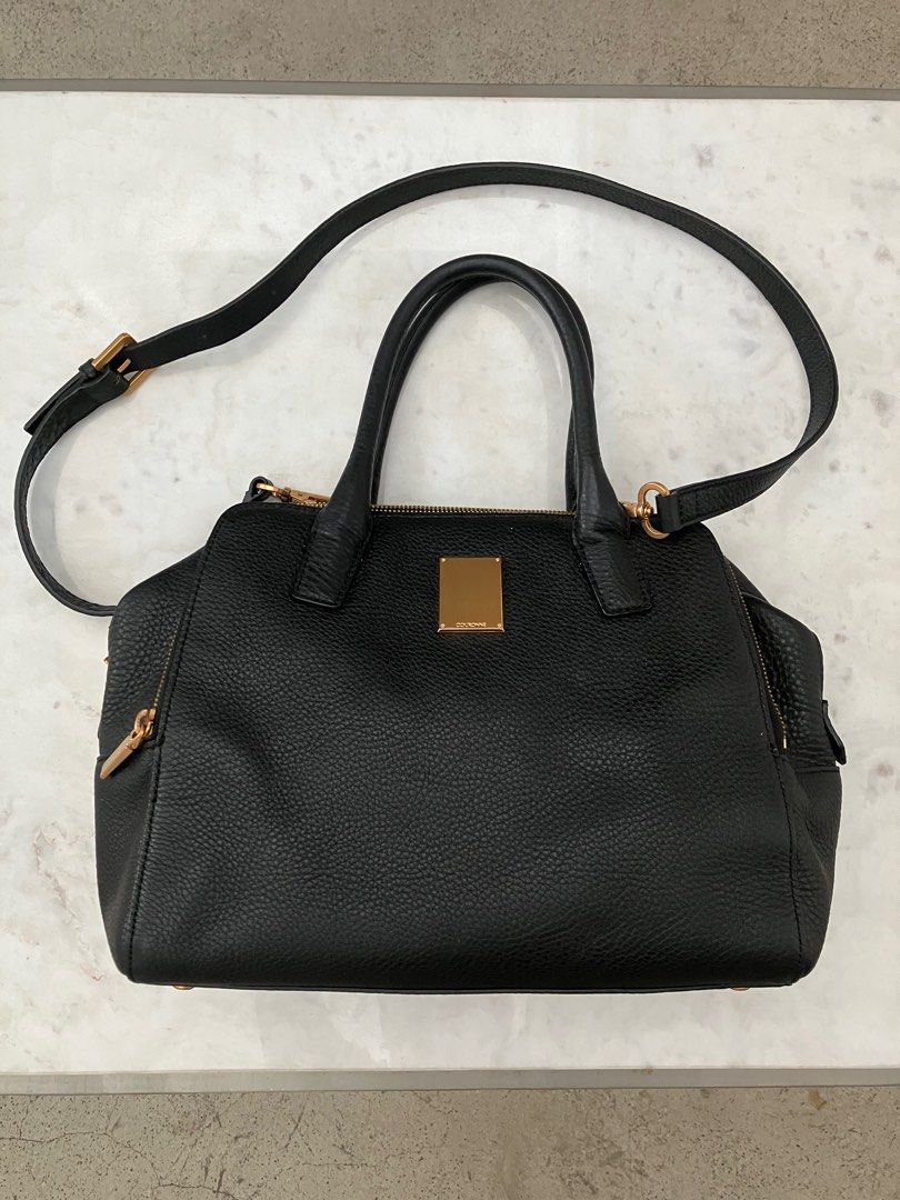 Couronne Black Leather Bowler style bag (Category: Luxury Bags & Wallets) located in Manila. Submitted by zolnak (Listing ID 1266696046, Image 1). Description: Authentic black pebbled leather bowler style bag. Triple zippered compartment with zippered interior pocket and 3 slip pockets inside middle compartment. 10 inch iPad can fit side compartment. Rose gold hardware. With metal feet. With sling strap. Zipper with minimal dark spots. Can be a s