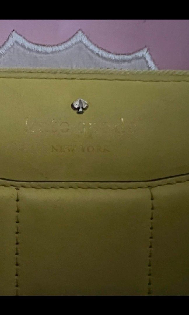 Kate Spade Yellow bow wallet (Category: Luxury Bags & Wallets) located in Quezon City. Submitted by uptrendglam (Listing ID 1267081443, Image 2). Description: Kate Spade light yellow bow wallet only issue is needs cleaningon the exterior side (check pics). RFS : Decluttering.