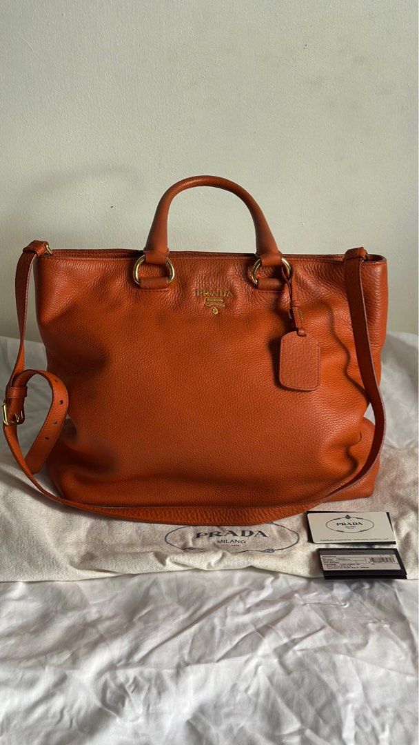 Prada Vitello Daino Papaya (Category: Luxury Bags & Wallets) located in Paranaque City. Submitted by mr.bbr (Listing ID 1267083492, Image 1). Description: Prada Vitello Daino Papaya Retail Price: $1,700 The Prada Vitello Daino Leather Tote Bag is one sophisticated piece. This durable and spacious tote has the capability to hold all your daily essentials and more. It is made of gorgeous rich pebbled Daino leather with a roomy interior and a remova