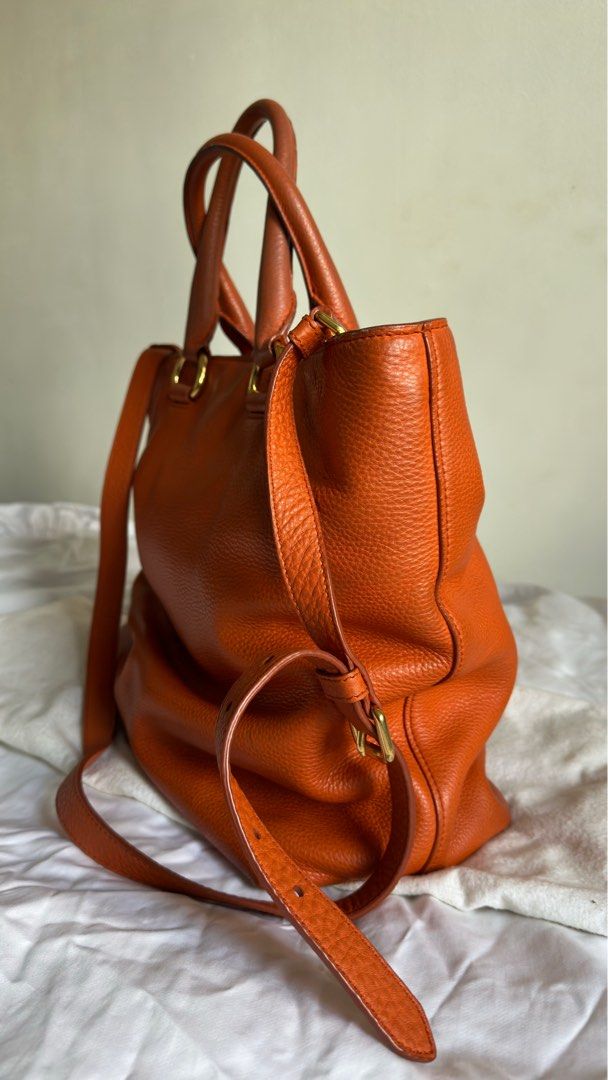 Prada Vitello Daino Papaya (Category: Luxury Bags & Wallets) located in Paranaque City. Submitted by mr.bbr (Listing ID 1267083492, Image 3). Description: Prada Vitello Daino Papaya Retail Price: $1,700 The Prada Vitello Daino Leather Tote Bag is one sophisticated piece. This durable and spacious tote has the capability to hold all your daily essentials and more. It is made of gorgeous rich pebbled Daino leather with a roomy interior and a remova