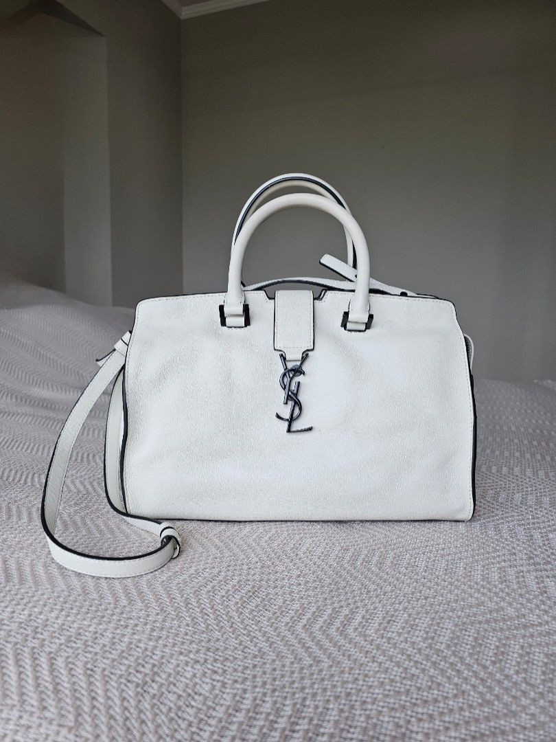 YSL Downtown Cabas Handbag white (Category: Luxury Bags & Wallets) located in Mandaluyong City. Submitted by elizadoolittl (Listing ID 1267085044, Image 1). Description: YSL Downtown Cabas handbag in white soft leather. Used only a few times. There are some small and hardly noticeable dirt on the outer leather (shown in photos), a speck of stain on the corner of the front handle, and a small streak of light blue pen ink near the zipper. Other tha