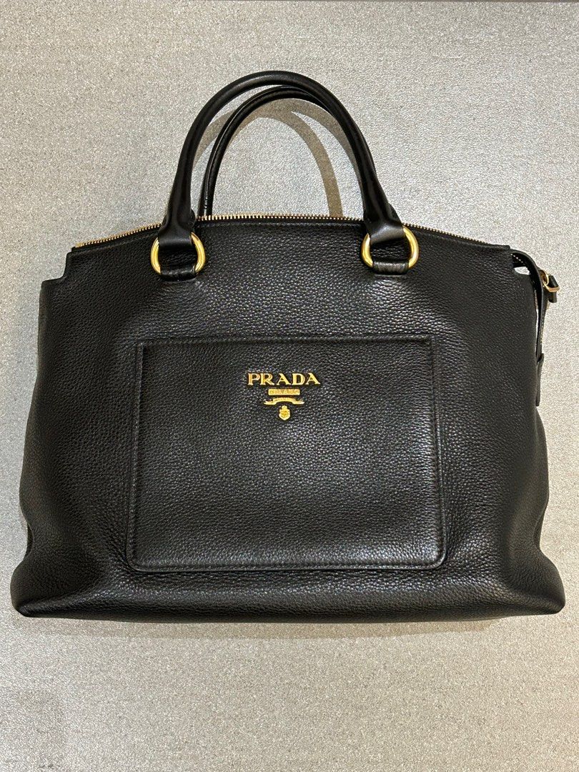 PRADA Black Vitello Daino Leather Top handle (Category: Luxury Bags & Wallets) located in Taguig. Submitted by j___jj (Listing ID 1267748592, Image 1). Description: Prada Black Vitello Daino Leather Top handle Bag makes a perfect, classic everyday bag. Like new, no flaws. Retail price $1700. The exterior leather is clean, no scratches. The handles and shoulder strap remain in good condition with no obvious signs of wear. The hardware is bright an
