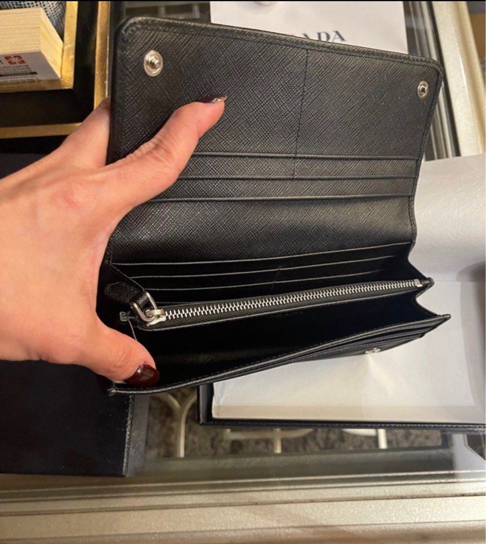 Authentic Prada Nero Wallet (Category: Luxury Bags & Wallets) located in Makati City. Submitted by kl080808 (Listing ID 1263629776, Image 3). Description: Selling my Authentic Prada Nylon Tessuto wallet, bi fold long wallet in Nero black. I personally purchased this at an outlet in Europe so guaranteed authentic!!! Used gently. As is where is. RFS - disposing my excess luxury items.