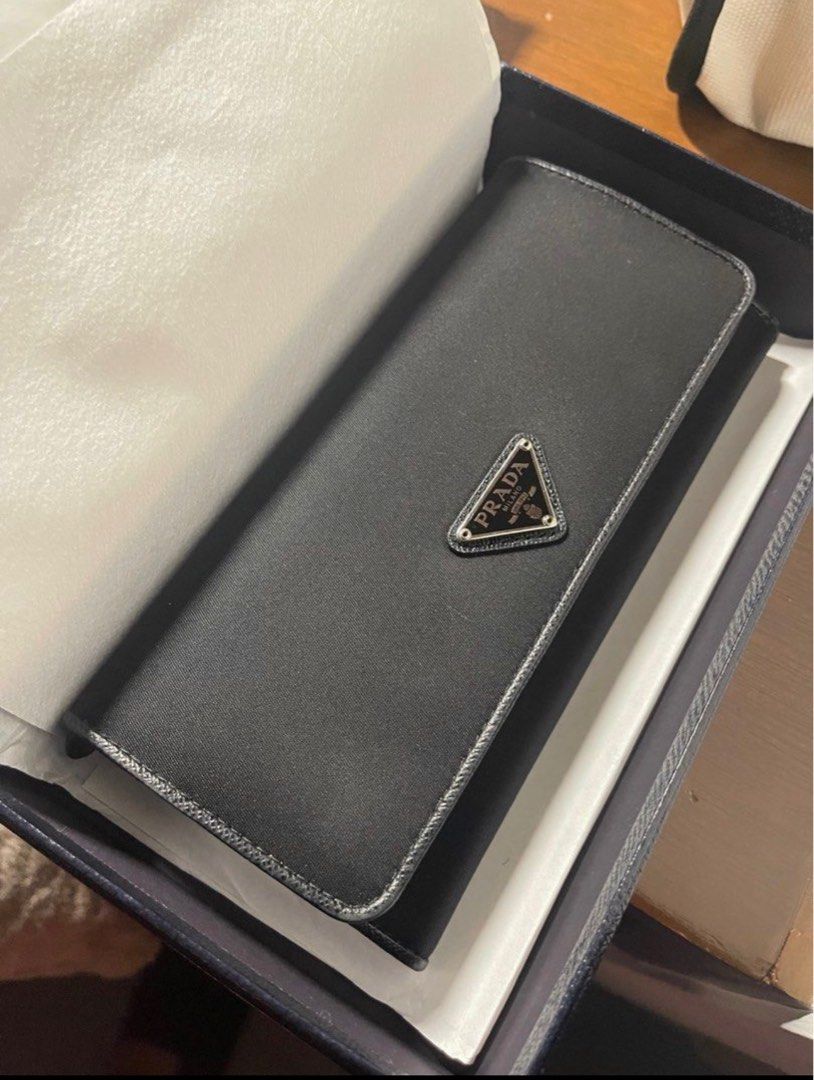 Authentic Prada Nero Wallet (Category: Luxury Bags & Wallets) located in Makati City. Submitted by kl080808 (Listing ID 1263629776, Image 2). Description: Selling my Authentic Prada Nylon Tessuto wallet, bi fold long wallet in Nero black. I personally purchased this at an outlet in Europe so guaranteed authentic!!! Used gently. As is where is. RFS - disposing my excess luxury items.