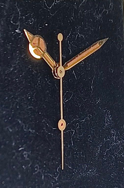 Gold watch hands top