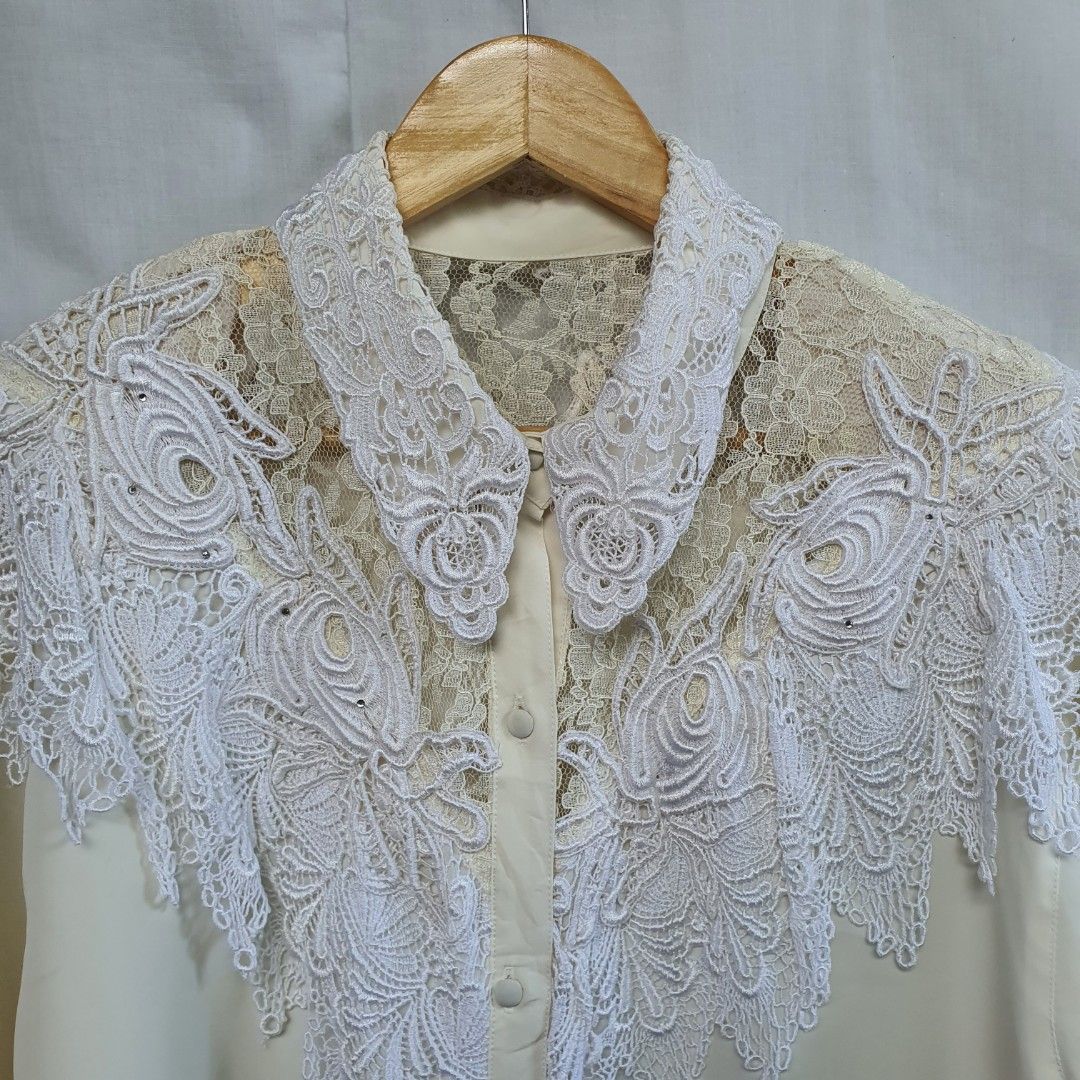 white vintage long sleeves top/blouse (Category: Longsleeves) located in Batangas. Submitted by ghostquire (Listing ID 1263948857, Image 2). Description: thrifted from ig! 🕊 features a classic vintage style with lace covering the top, shoulder padding, and covered buttons. can be paired with black trousers for a classic 80’s look! best fits m-l for your reference: width (pit to pit) 22” length 26” sleeve length 21” helping tags: pinterest aesthe