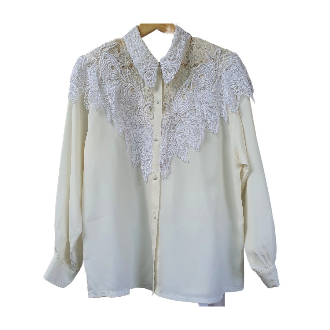 white vintage long sleeves top/blouse (Category: Longsleeves) located in Batangas. Submitted by ghostquire (Listing ID 1263948857, Image 1). Description: thrifted from ig! 🕊 features a classic vintage style with lace covering the top, shoulder padding, and covered buttons. can be paired with black trousers for a classic 80’s look! best fits m-l for your reference: width (pit to pit) 22” length 26” sleeve length 21” helping tags: pinterest aesthe
