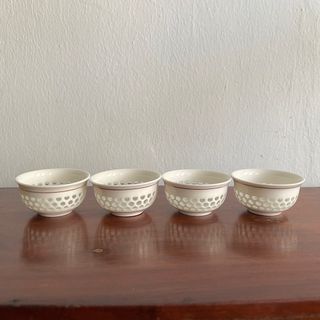 4 glazed Chinese teacups with see through cut outs.