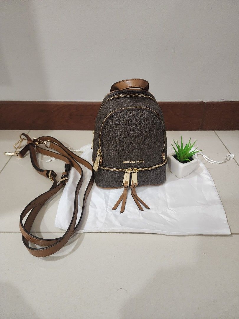 Mini Backpack (Category: Backpacks) located in Singapore. Submitted by tin15 (Listing ID 1268703860, Image 1). Description: MK small backpack/crossbody, used in a very good condition, got the straps shorten see other photos, i will include the strap extender for free. Selling at $200.