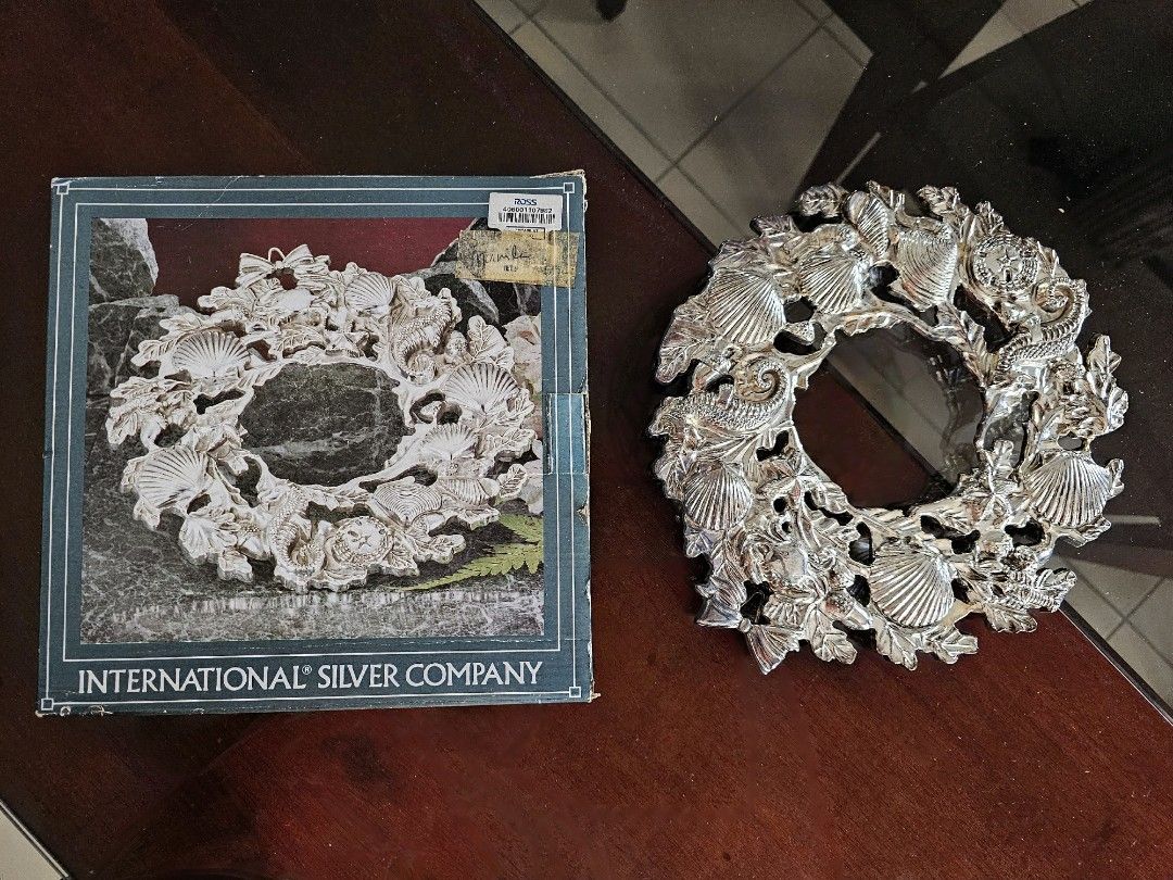 Silver plated trivet/countertop protector (Category: Cookware & Accessories) located in Manila. Submitted by great_buys (Listing ID 1268727836, Image 2). Description: Serve in style with this silverplated antique finish trivet with marine animals design, 9 3/8 inches in length. Made by International silver company. Comes in original box..