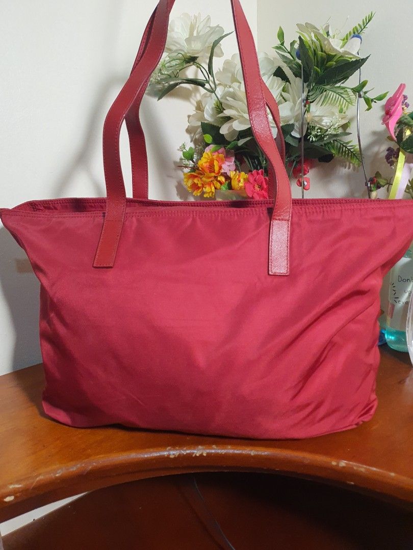 Authentic💯 Prada Red Nylon Tote Bag (Category: Luxury Bags & Wallets) located in Tagum. Submitted by maryjanepradalux (Listing ID 1272442969, Image 3). Description: *No inclusion *No Flaws *No Issue *Slightly used *bought from singapore *Money Back Guarantee if proven fake *Pm for more details.