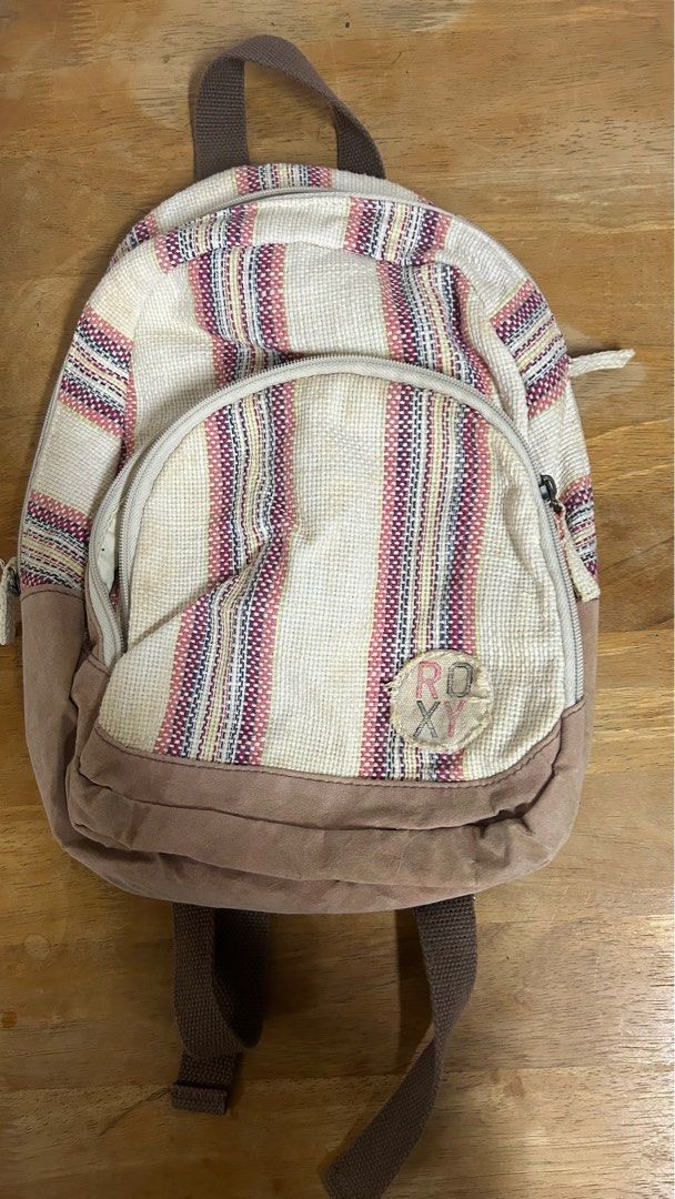 Roxy small light colored backpack (Category: Backpacks) located in Makati City. Submitted by acebunni (Listing ID 1272280291, Image 1). Description: PLEASE READ DESCRIPTION AND CHECK ALL PHOTOS FIRST ————— Roxy Girl small white backpack ₱600 + sf Dimensions: From the back: L 32cm x W 19cm On the base: L 19cm x W 11cm (estimate thickness) - well used - minor flaws on base from usage (see photo) - zippers are okay - adjustable straps - spacious eno