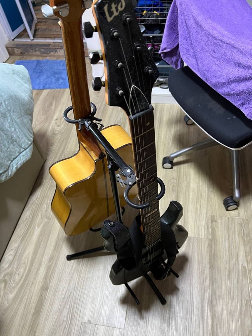 An electric guitar, and an acoustic guitar with a rack, Hobbies & Toys