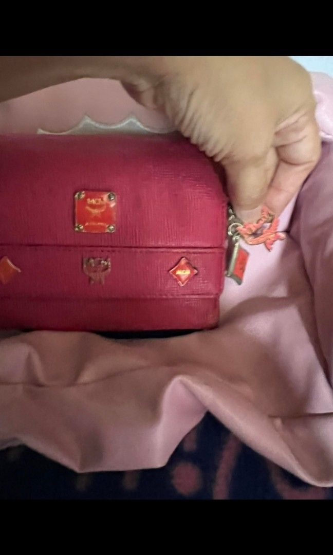 MCM small wallet (Category: Luxury Bags & Wallets) located in Quezon City. Submitted by uptrendglam (Listing ID 1268932244, Image 2). Description: MCM small wallet with charms. Issue: needs cleaning, tarnish gold hardware, minor rubs.