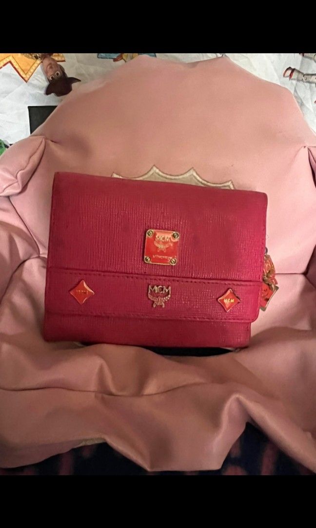 MCM small wallet (Category: Luxury Bags & Wallets) located in Quezon City. Submitted by uptrendglam (Listing ID 1268932244, Image 1). Description: MCM small wallet with charms. Issue: needs cleaning, tarnish gold hardware, minor rubs.