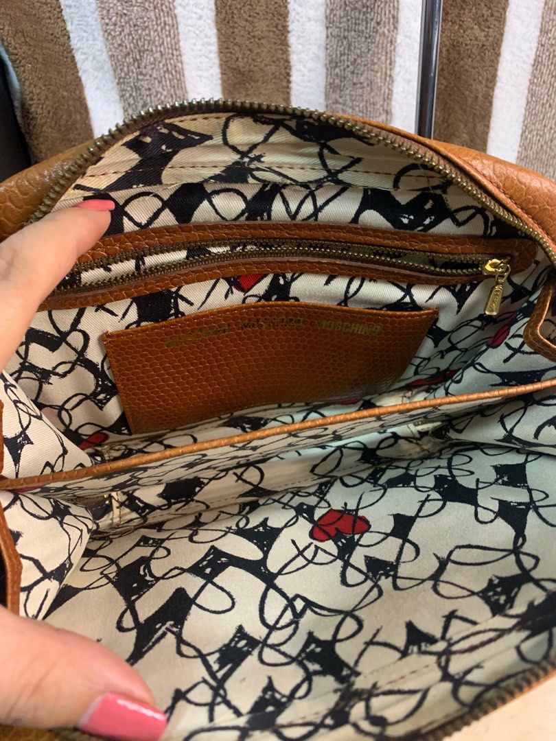 Auth vintage leather moschino clutch bag (Category: Luxury Bags & Wallets) located in Cabanatuan. Submitted by mjluxxejapan (Listing ID 1273142268, Image 3). Description: NO LP PLS.good cond.genuine leather.approx 10.5”x8” meas.cute and pretty in actual.minimal signs of use as normal due to its aged.(small dirts on bottom) .