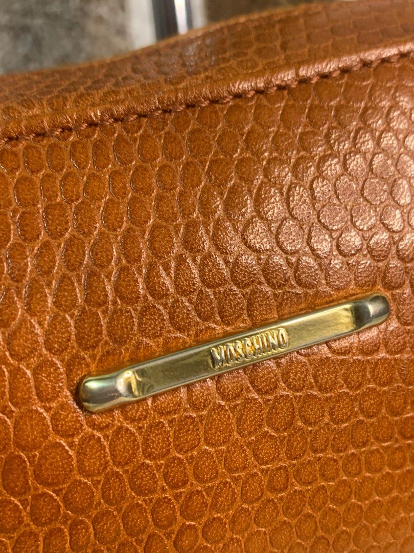 Auth vintage leather moschino clutch bag (Category: Luxury Bags & Wallets) located in Cabanatuan. Submitted by mjluxxejapan (Listing ID 1273142268, Image 2). Description: NO LP PLS.good cond.genuine leather.approx 10.5”x8” meas.cute and pretty in actual.minimal signs of use as normal due to its aged.(small dirts on bottom) .