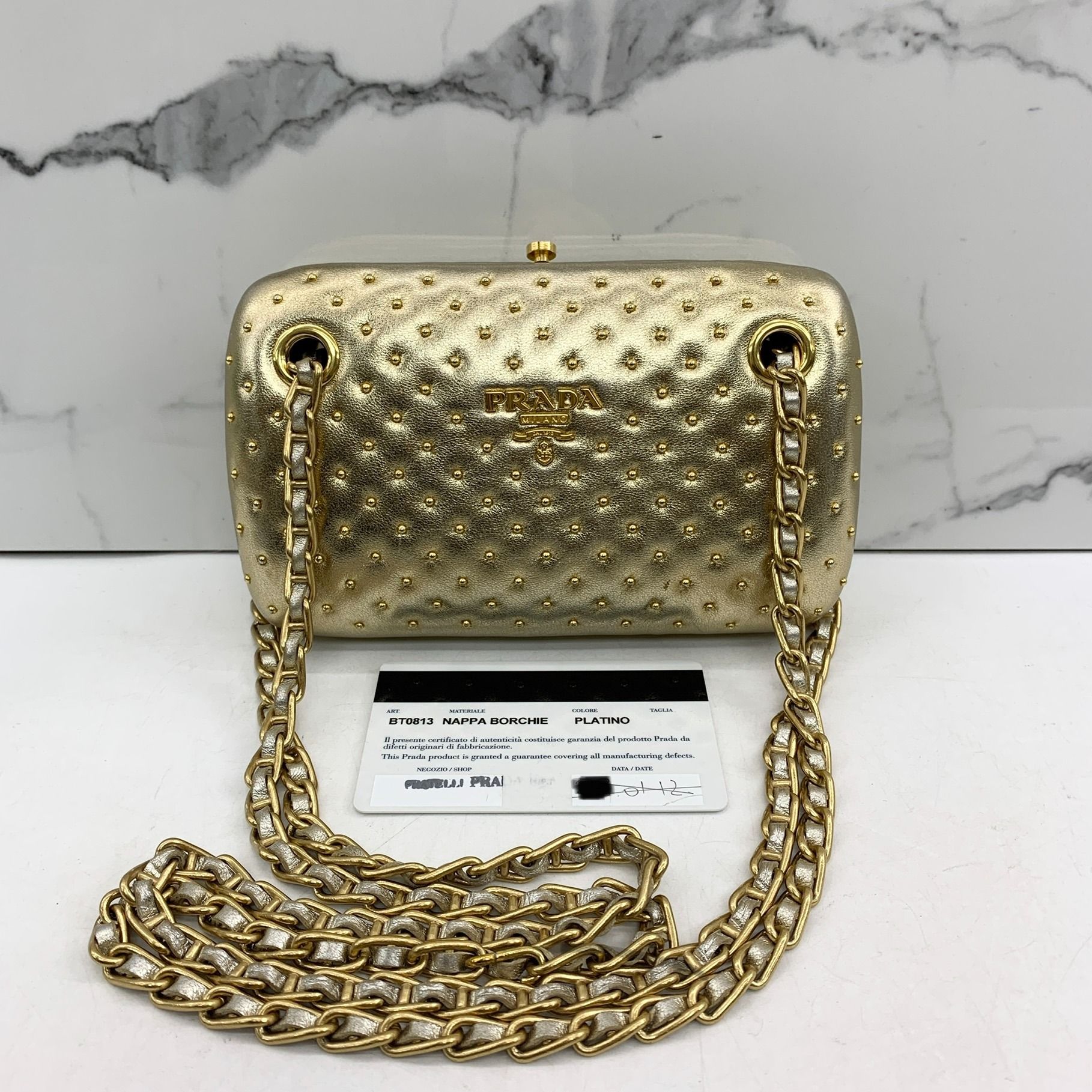 Prada gold logo clutch new arrivals