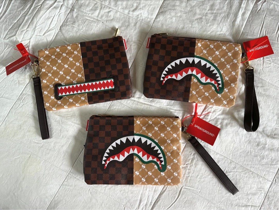 Sprayground Clutch Bag | Christmas Gift Idea (Category: Luxury Bags & Wallets) located in Pasig City. Submitted by tsunami22 (Listing ID 1273503501, Image 2). Description: Last Minute Christmas Present? We Got you! 🎄🎅🏻 Sprayground Clutch Bag All Brandnew With Tags Unisex ₱2,799 only‼️ Pouch with removable wristlet strap, Handle on front panel, Zip Closure, secret stash pocket on side seam 1 interior pocket 7” X 10” X 0.25” Unisex.