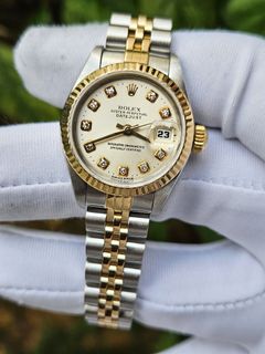 Gold women's rolex with diamonds top