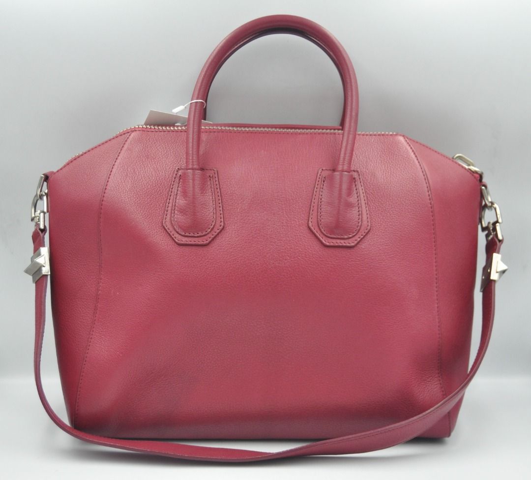 Givenchy - F/W 14 - Medium Antigona (Category: Luxury Bags & Wallets) located in Manila. Submitted by graymatter_ (Listing ID 1274261912, Image 2). Description: Givenchy - F/W 14 - Medium Antigona Color: Magenta Tagged Size: M Condition: Rank A Flaws: Small Bumps on 1 Side, Light Uneven Shade, Chipping Behind the Handle Material: Goatskin Leather Made in: Italy SRP: $2,450 Dimensions Height: 28cm Width: 33cm Depth: 19m .