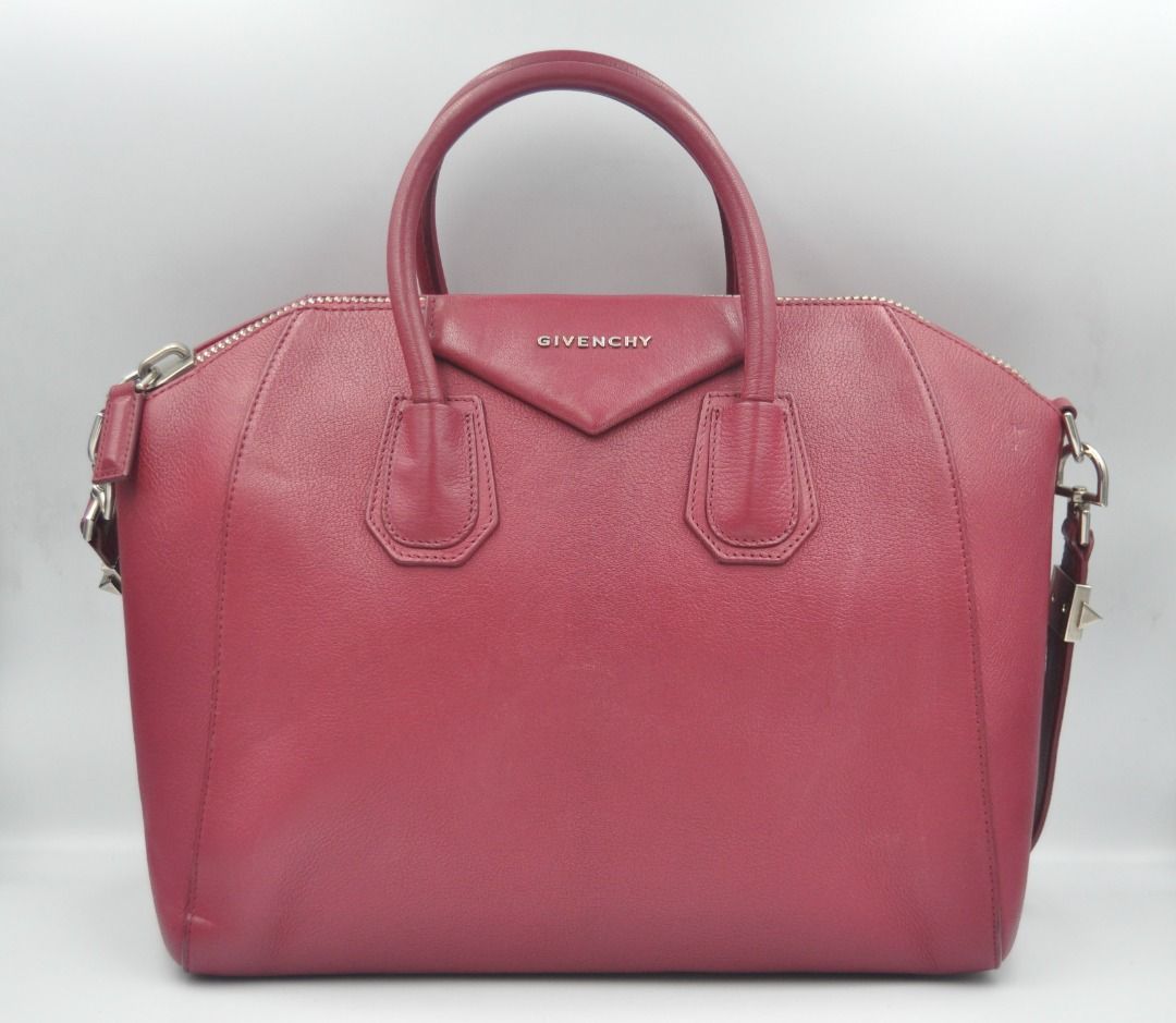 Givenchy - F/W 14 - Medium Antigona (Category: Luxury Bags & Wallets) located in Manila. Submitted by graymatter_ (Listing ID 1274261912, Image 1). Description: Givenchy - F/W 14 - Medium Antigona Color: Magenta Tagged Size: M Condition: Rank A Flaws: Small Bumps on 1 Side, Light Uneven Shade, Chipping Behind the Handle Material: Goatskin Leather Made in: Italy SRP: $2,450 Dimensions Height: 28cm Width: 33cm Depth: 19m .