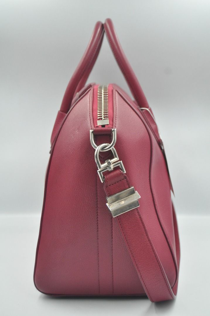 Givenchy - F/W 14 - Medium Antigona (Category: Luxury Bags & Wallets) located in Manila. Submitted by graymatter_ (Listing ID 1274261912, Image 3). Description: Givenchy - F/W 14 - Medium Antigona Color: Magenta Tagged Size: M Condition: Rank A Flaws: Small Bumps on 1 Side, Light Uneven Shade, Chipping Behind the Handle Material: Goatskin Leather Made in: Italy SRP: $2,450 Dimensions Height: 28cm Width: 33cm Depth: 19m .
