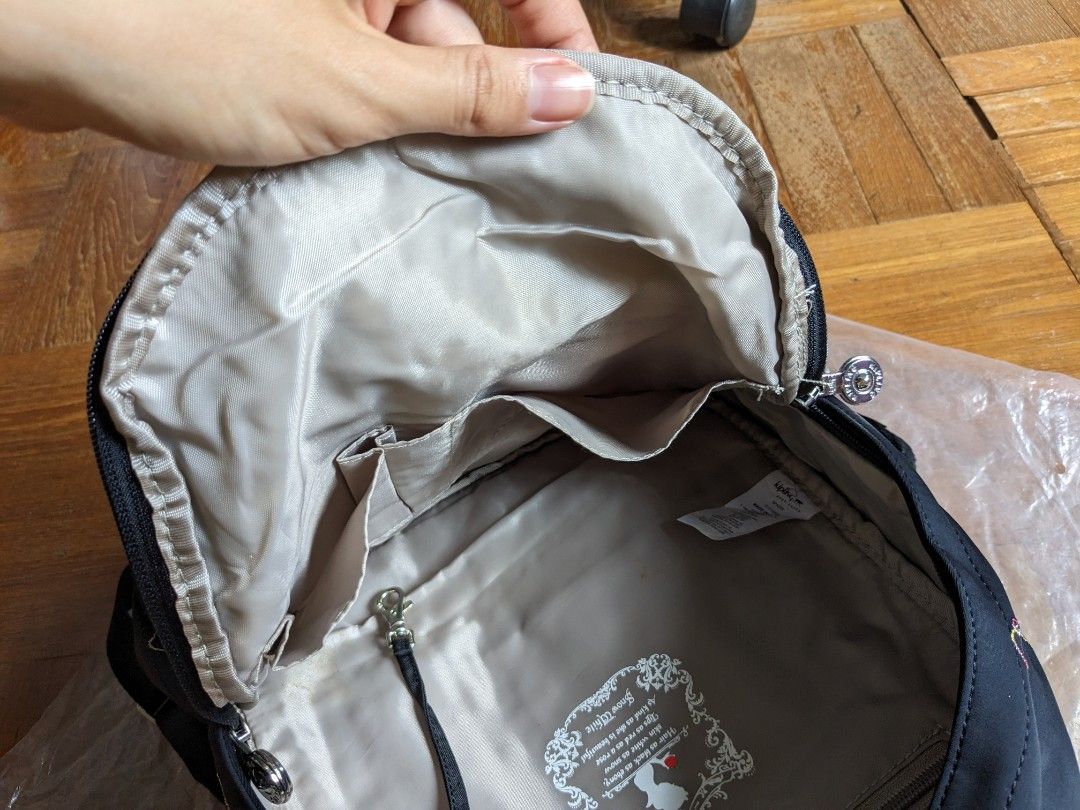 [Kipling] Backpack (Category: Backpacks) located in Singapore. Submitted by dilutedwater (Listing ID 1274166994, Image 4). Description: Kipling Backpack - Disney Snow White Colour: Black/Multi rainbow embroidery Measurements: 21.5cm L x 10.5cm W x 30cm H Handle strap: 2 shoulder straps, 1 handle Design: 1 main zipper compartment, 1 front zipper pocket Interior details: 1 zipper pocket, 2 side pockets, 2 pen slots Condition: 10/10 Meetups: Harbour