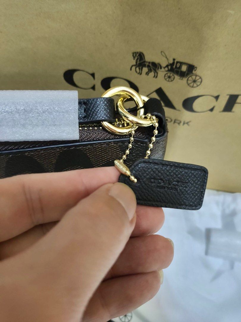 Coach top handle pouch in signature canvas store